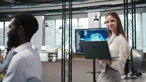 Portrait of young smiling female programmer in office automating repetitive tasks using AI scripts. Cheerful junior developer using artificial intelligence to speed up feature implementation, camera A - Powered by Shutterstock - Get 15% off with code: PIKWIZARD15