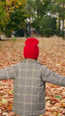 Kid girl running in park on yellow autumn leaves. Concept of children happiness of happy family. Child run, playing in autumn park. Child run, play dreams in fresh air. Active girl, happy emotions