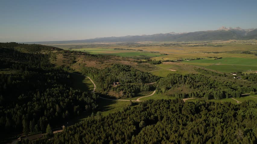 Aerial above forested neighborhoods in Victor idaho in Big Hole Mountains