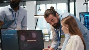 Young inexperienced developer in office requests help from team to fix hacking attempt on corporate network. Intern assisted by colleagues to investigate unauthorized access alerts, camera A - Powered by Shutterstock - Get 15% off with code: PIKWIZARD15