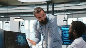 Startup engineer and colleague with paraplegia brainstorming, working with machine learning tech. Man in wheelchair and coworker in office transforming data into AI predictive models, camera A - Powered by Shutterstock - Get 15% off with code: PIKWIZARD15