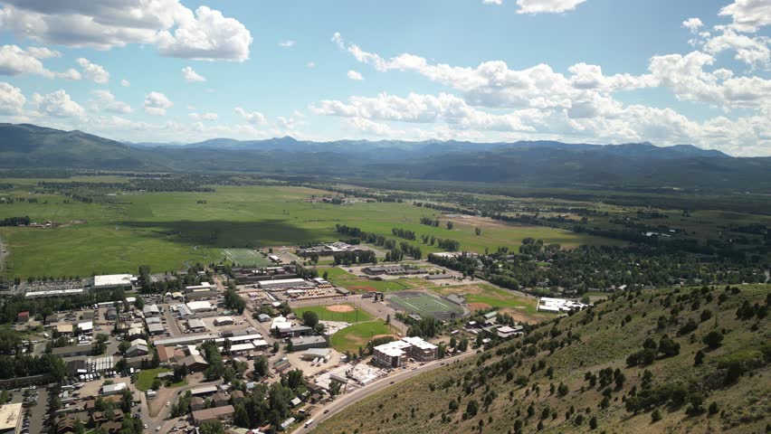 Aerial of town of Jackson Wyoming in valley and mountains in summer in Tetons