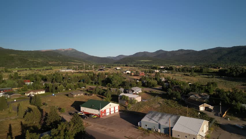 Aerial over rural mountain homes in town of Victor Idaho in summer in Big Hole Mountains