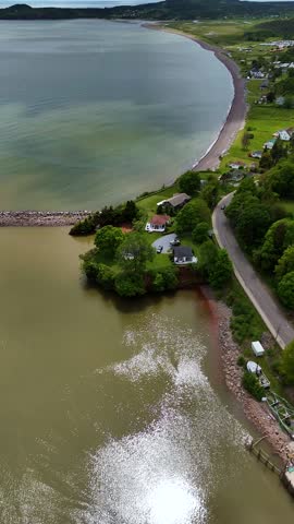Aerial view of the colourful sea and shoreline in Saint-Martins, New-Brunswick, Canada.  