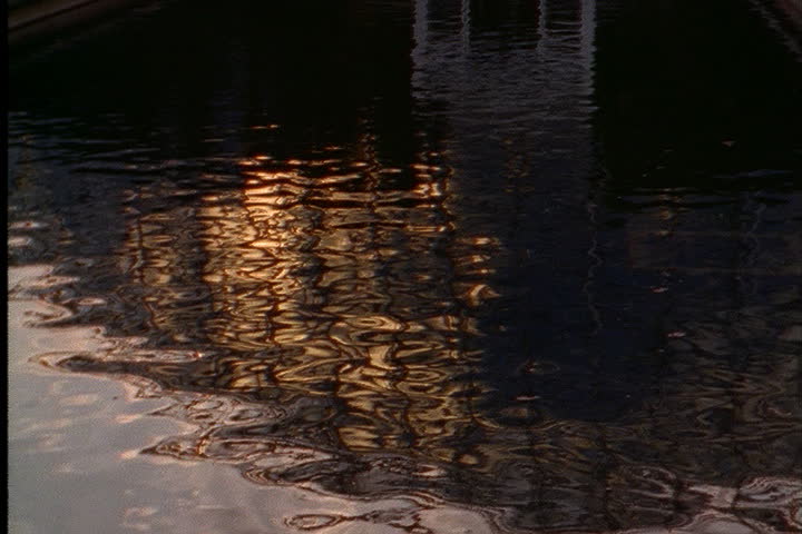 ST. LOUIS - CIRCA MARCH 2000: Sunset reflecting in pool, tilt up to Climatron dome with pink light shining through.
