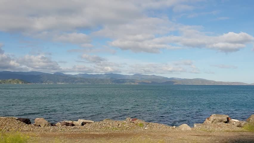 Scenic view of Wellington harbour from moving train window in capital city of Wellington, New Zealand Aotearoa