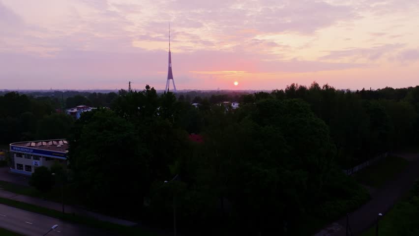 Cinematic aerial reveals Riga’s dawn skyline with iconic TV tower near Bišumuiža