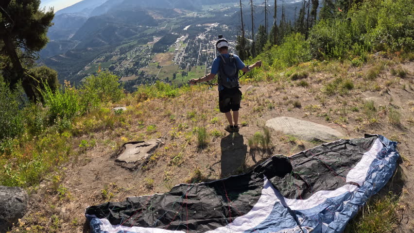 POV of two speedflyers launching in sequence near mountain terrain—one takes off, another follows. Raw action showing skill, trust in equipment, and the intensity of high-speed free flight.