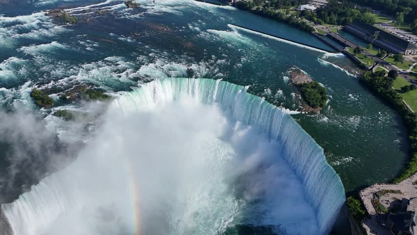 Drone flies straight down over Horseshoe Falls, descending into the mist to reveal the powerful, swirling currents at the base of the waterfall