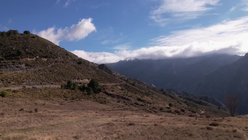 Hyperlapse. Sierra Nevada. Snow-capped mountains and clouds moving at high speed while flying over mountainous terrain. Granada. Spain.