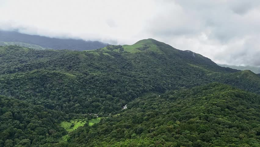 An epic aerial view of Mallalli Waterfalls flowing amidst lush green mountains and forests during the rainy day.mesmerizing view of a secret waterfalls amidst jungle.tourism concept.travel concept