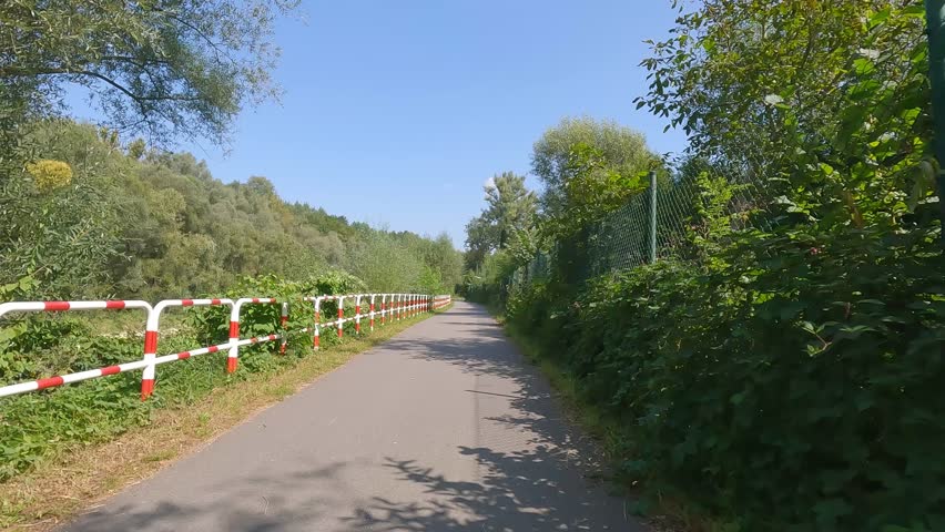 POV cycling shot on Velo Sola bike path in Beskid Zywiecki with safety rail and greenery on both sides