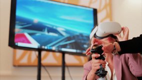 Woman wearing a Virtual Reality headset, playing games, holding a handle - Powered by Shutterstock - Get 15% off with code: PIKWIZARD15