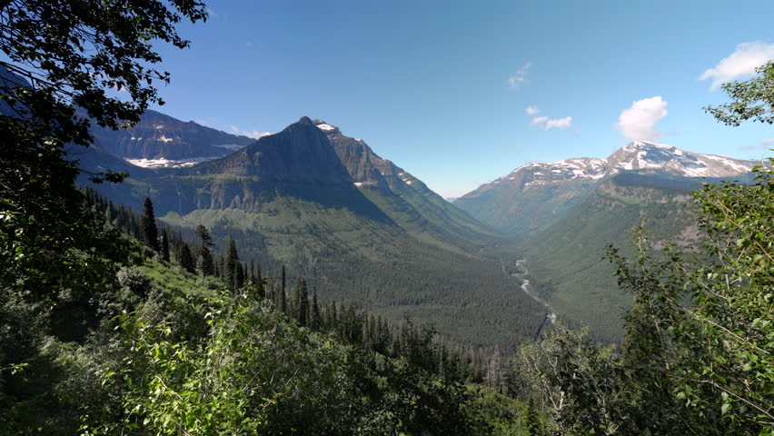 Immerse yourself in the stunning landscapes of Glacier National Park in Montana, featuring majestic mountains, lush valleys, and expansive skies that captivate the senses at every turn