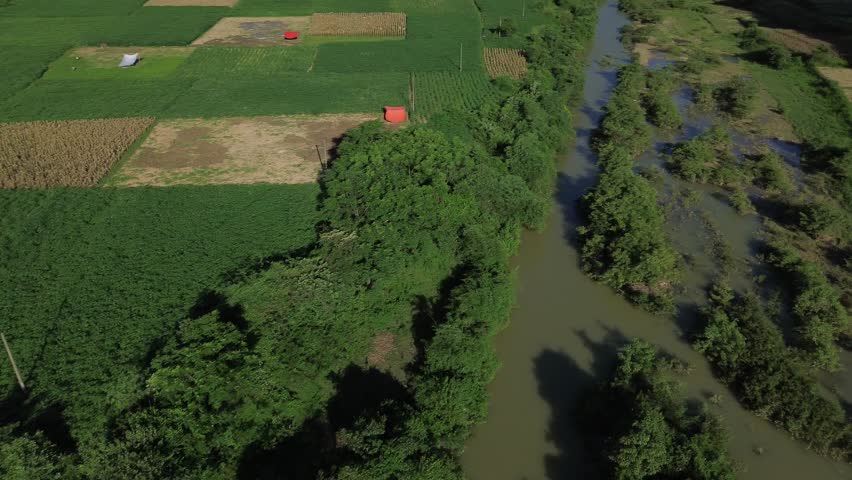 Pan left showing rice fields and river snaking through karst landscape in Phong Nha.