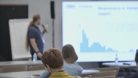 Speaker presenting graph data to audience during business workshop. Professional training environment fostering development and learning. Interactive session for knowledge sharing skill enhancement. - Powered by Shutterstock - Get 15% off with code: PIKWIZARD15