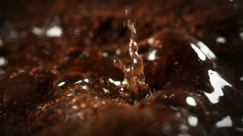 Super Slow Motion Detail Shot of Brewing Ground Coffee with Hot Water at 1000fps.