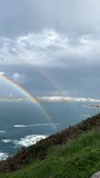 Double rainbow over rocky coast and city skyline by the sea - Powered by Shutterstock - Get 15% off with code: PIKWIZARD15