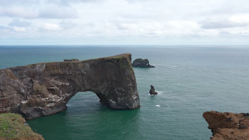 Outdoors, Iceland landscape from height, view of the ocean and majestic cliffs on the horizon, view of the huge coastal area, earth texture, dark sand, shore nature background.