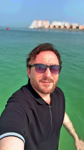Young Asian man enjoy the view of Jumeirah Beach Dubai