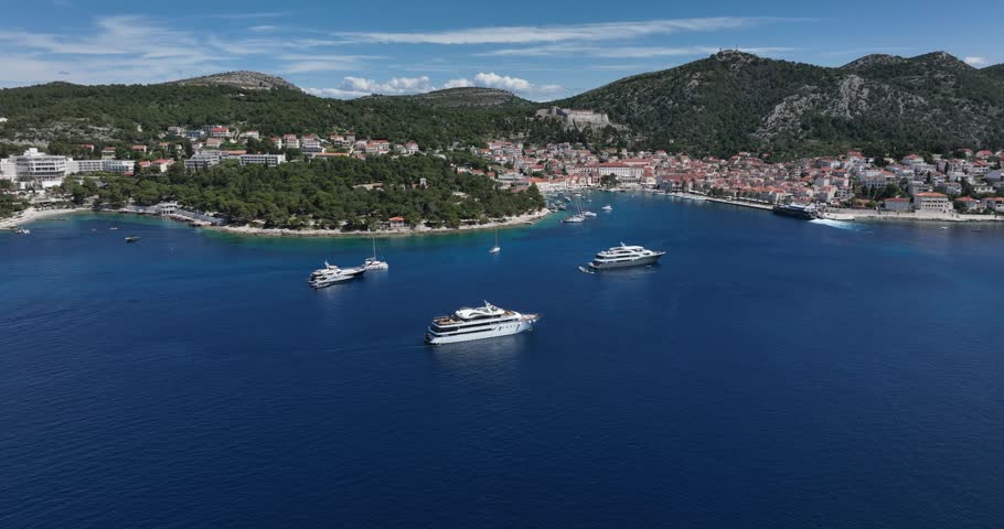 Capturing of Hvar Island with yachts on sea and beautiful hilly landscape in Croatia. Aerial view.