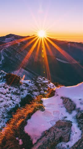 Winter Sunset in Snowy Alps Mountains with Golden Light Sunbeams, Vertical Nature Time Lapse