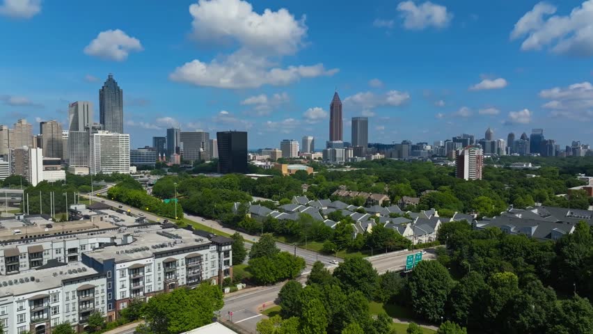 Aerial View Of Highway, Green Trees, Houses with Downtown Atlanta In Georgia, USA.