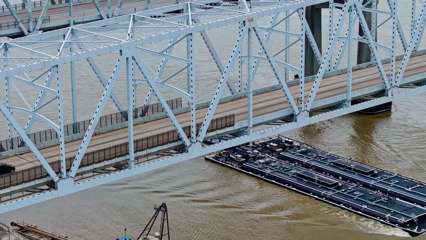 Aerial View Of Barge Cruising In Mississippi River Under The Crescent City Connection Bridge In New Orleans, Louisiana, USA.