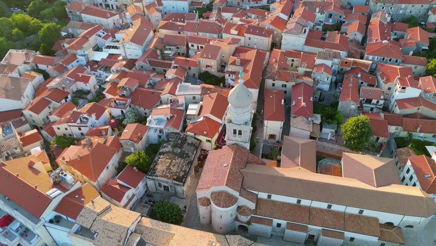 Aerial View of Krk, the Capital City of the Croatian Island of Krk, Adriatic Coast, With Harbor and Red Tiled Roofs. Blue Sea,with Sailboats, Sandy Beaches and the Historic Old Town at Sunset Croatia