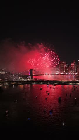 Large fireworks on New York bridge to celebrate 4th of July, aerial vertical