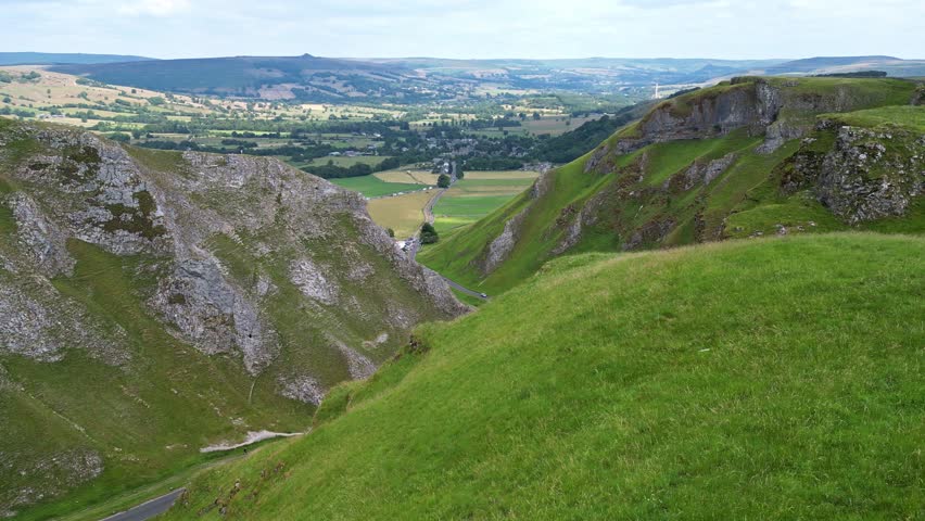 Idyllic aerial footage of the Winnats Pass. Picturesque mountain pass and a winding road. Peak District, Derbyshire, England, UK