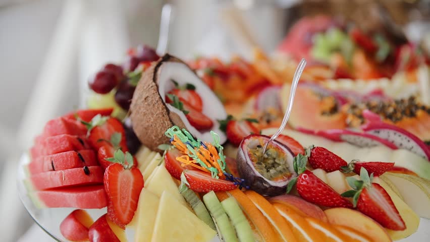 Beautifully decorated catering platter displaying a variety of fresh exotic fruits, ready to be served
