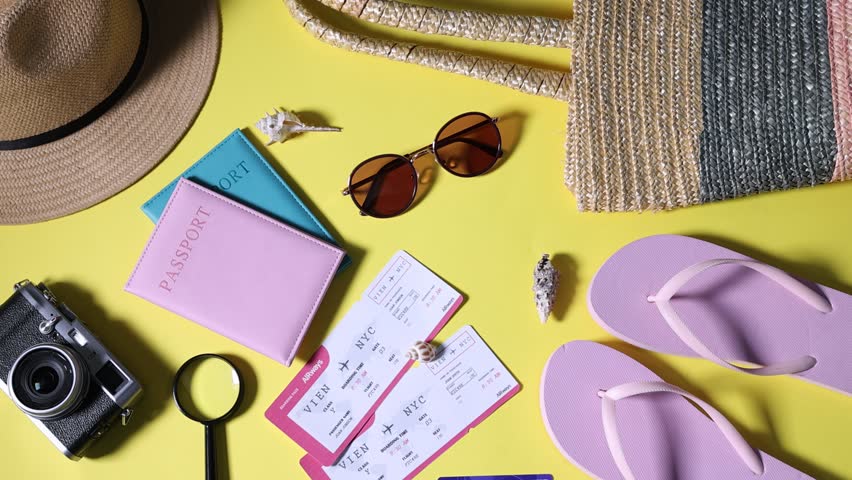 Woman with airplane model, passports, flight tickets, vintage photo camera and accessories on yellow background, top view