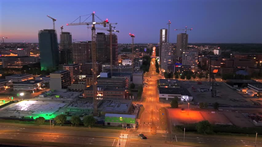 High-Rise Construction with Tower Cranes in Amsterdam South at Dusk