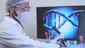A scientist in a genetics lab analyzes DNA data, with a double helix on the screen. Concept for genomic research, gene editing, and the future of personalized medicine. - Powered by Shutterstock - Get 15% off with code: PIKWIZARD15