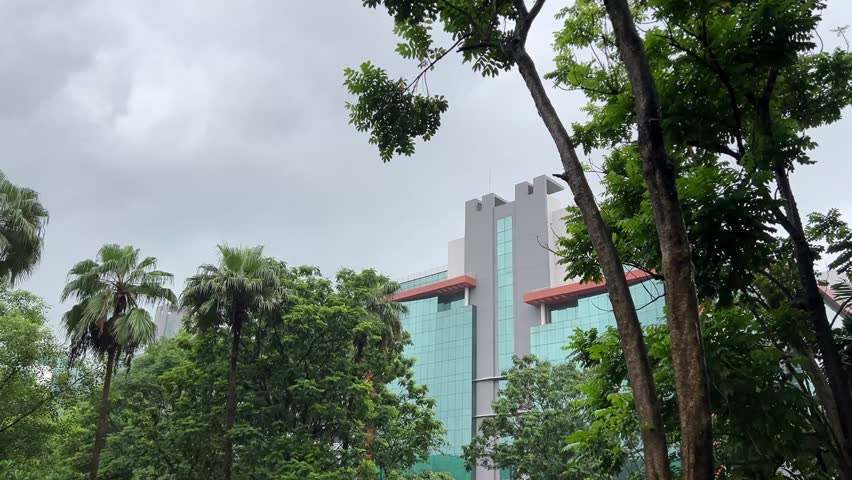 Indian multi national office building during cloudy day in between trees