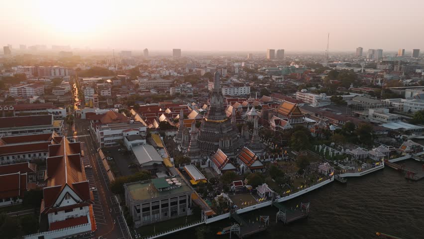Wat arun temple, ratchawararam ratchawaramahawihan in Bangkok, Thailand during a vibrant sunset. Travel landmark. 