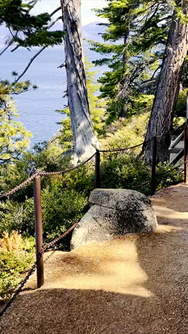 View, POV walking down mountain stone path by lake Tahoe in California. Walking tourist route near the lake in the mountains