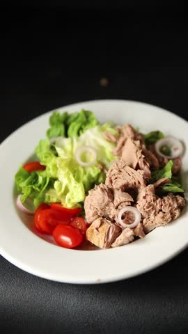 Tuna salad green leaf lettuce, canned tuna, tomato fresh delicious gourmet food background on the table rustic food top view copy space keto and paleo diet vegetarian food pescetarian diet