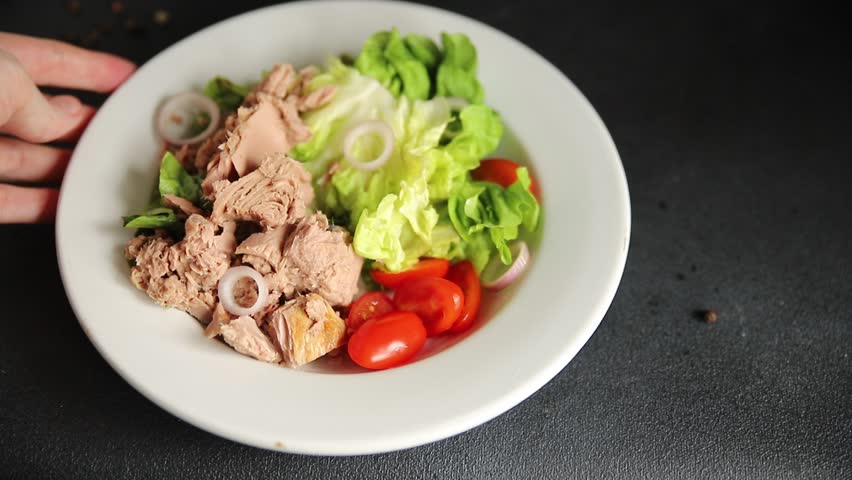 Tuna salad green leaf lettuce, canned tuna, tomato fresh delicious gourmet food background on the table rustic food top view copy space keto and paleo diet vegetarian food pescetarian diet