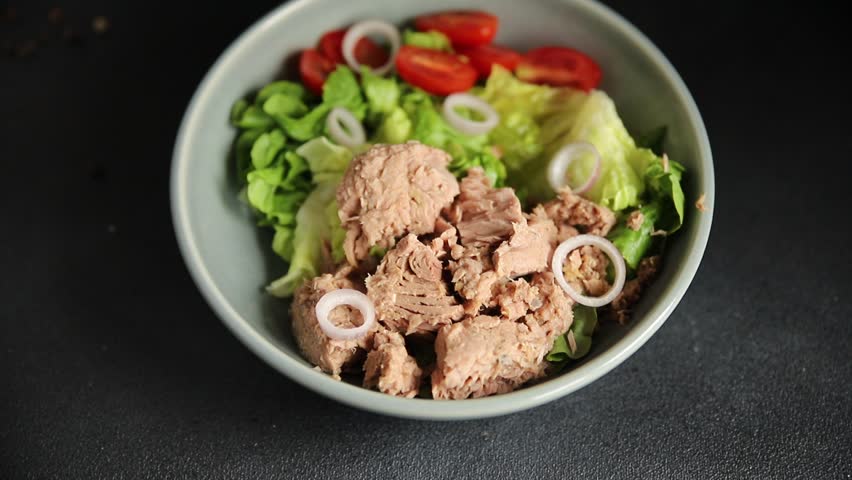 Tuna salad green leaf lettuce, canned tuna, tomato fresh delicious gourmet food background on the table rustic food top view copy space keto and paleo diet vegetarian food pescetarian diet