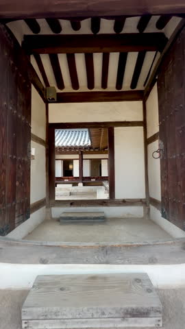 A traditional Korean architectural interior with wooden beams and sliding doors, displaying the simplicity and elegance of Korean design, tc01