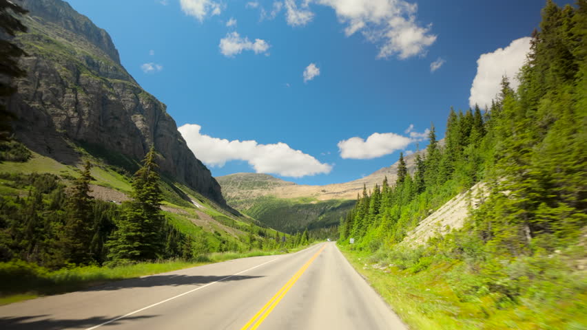 Stunning landscapes of Glacier National Park, going to the sun road featuring lush greenery, majestic mountains, and scenic roads surrounded by breathtaking natural beauty in every direction