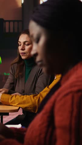Vertical Video Colleagues disturbing a woman with their loud reading in the library, african american pupil making a noise complaint and being disturbed by the disrespect. Breaking the rules. Camera A