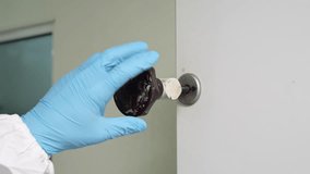 Close-up of a pharmaceutical lab worker in sterile uniform and gloves opening a sealed process chamber with a rotating handle in a cleanroom facility. - Powered by Shutterstock - Get 15% off with code: PIKWIZARD15