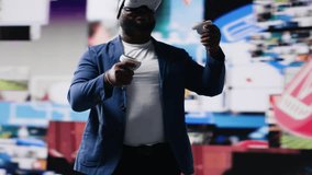 African american influencer using virtual reality glasses in mobile apps world, examining cloud data, visual content and emphasizing presence across tech platforms and social networks. Camera B. - Powered by Shutterstock - Get 15% off with code: PIKWIZARD15