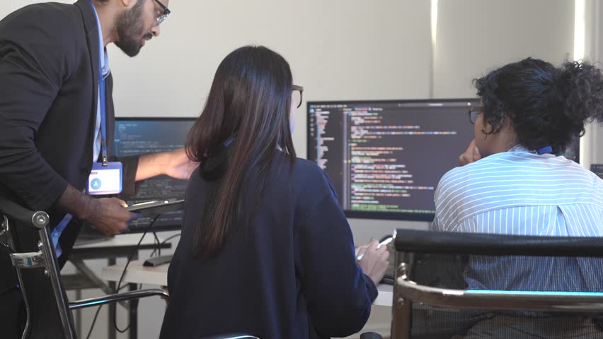 Agile team leader guiding diverse software developers in a sprint planning meeting. Multicultural group collaborating on a new project, reviewing complex code on a computer screen. - Powered by Shutterstock - Get 15% off with code: PIKWIZARD15