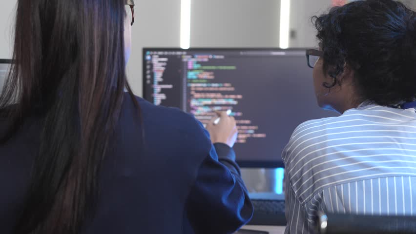 Agile team leader guiding diverse software developers in a sprint planning meeting. Multicultural group collaborating on a new project, reviewing complex code on a computer screen. - Powered by Shutterstock - Get 15% off with code: PIKWIZARD15