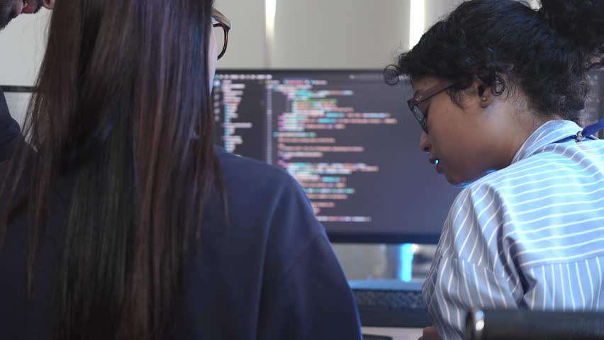 Agile team leader guiding diverse software developers in a sprint planning meeting. Multicultural group collaborating on a new project, reviewing complex code on a computer screen. - Powered by Shutterstock - Get 15% off with code: PIKWIZARD15