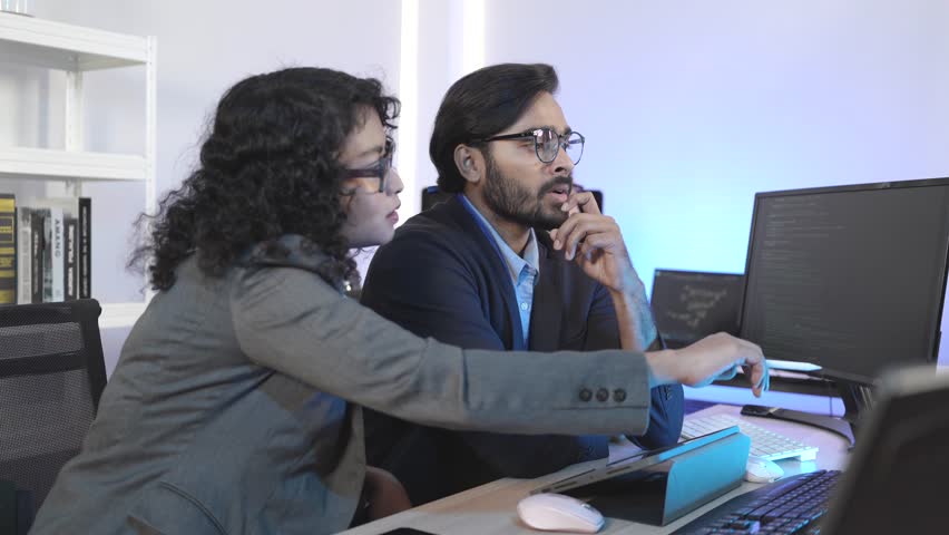 Diverse team of IT professionals collaborating on an AI project. A male manager mentors female colleagues in a modern office, analyzing data on a computer screen for digital transformation. - Powered by Shutterstock - Get 15% off with code: PIKWIZARD15